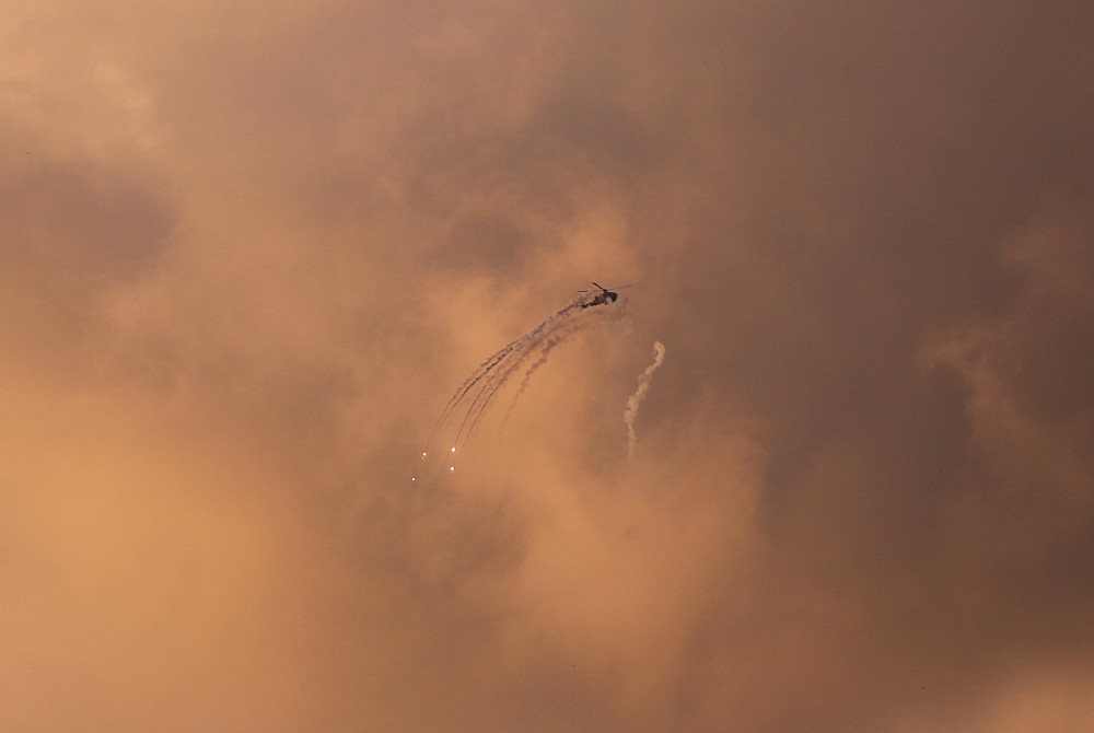 An Israeli Apache helicopter releases flares as it flies over the Gaza Strip March 25, 2019. u00e2u20acu201d Reuters pic