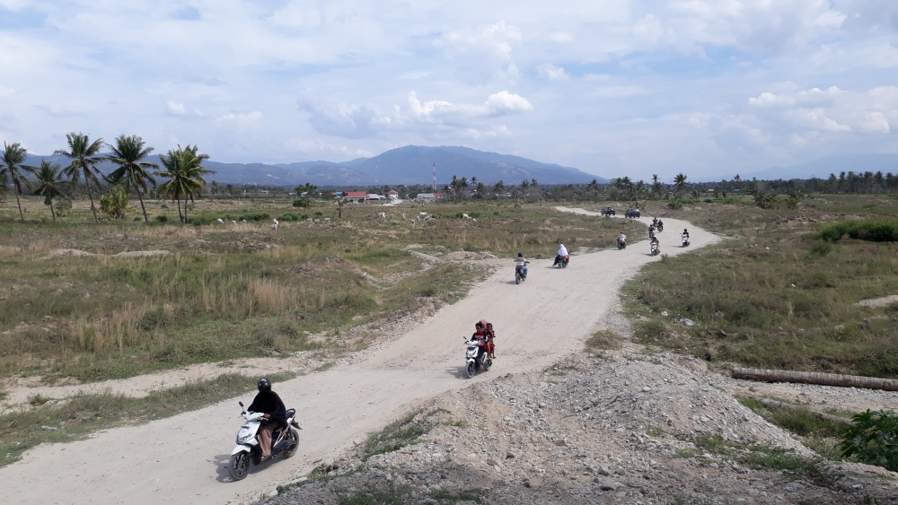 Palu villagers drive across a temporary road on the liquefaction site at Baloroa, which has since been marked as a red zone for all forms of development. u00e2u20acu201d Picture courtesy of Mercy Malaysia