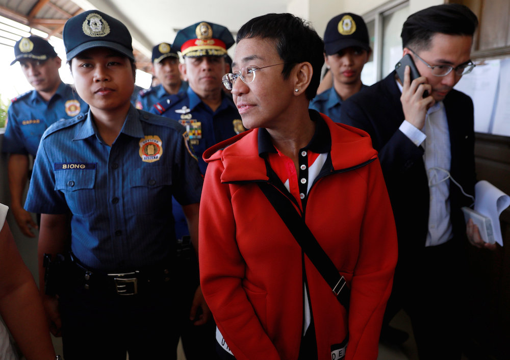 Rappler CEO and Executive Editor Maria Ressa is escorted by police after posting bail in Pasig Regional Trial Court in Pasig City, Philippines, March 29, 2019. u00e2u20acu201d Reuters pic