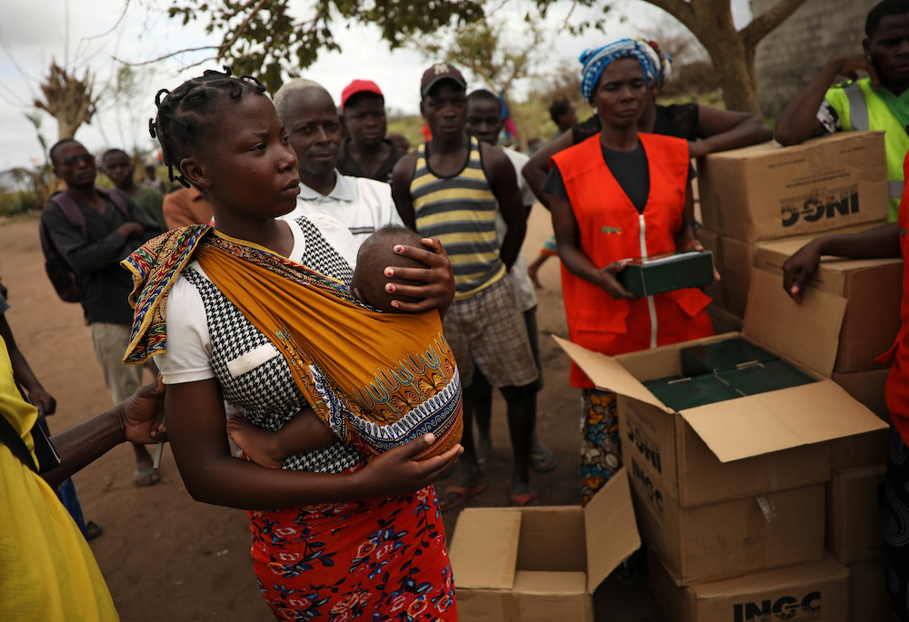 A woman waits with her child as aid is distributed at a camp for people displaced in flooding in the aftermath of Cyclone Idai, near Beira, Mozambique, March 23, 2019. u00e2u20acu201d Reuters pic