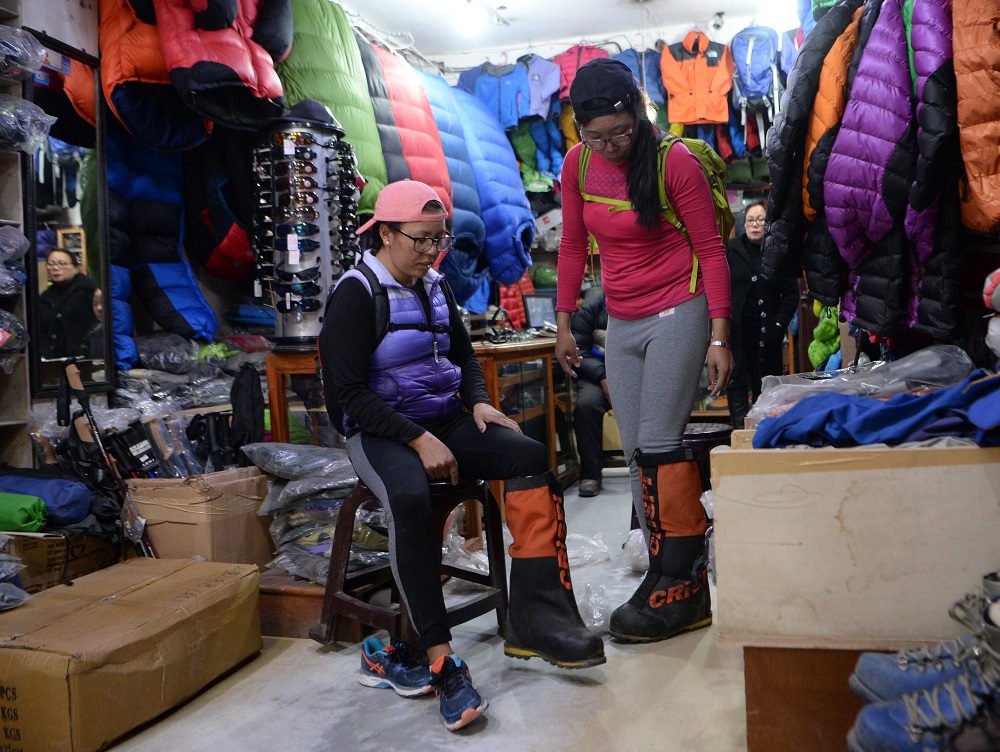 In this picture taken on February 12, 2019, Furdiki Sherpa (left) and Nima Doma Sherpa, the Nepali widows of mountaineers, prepare for their Everest expedition at a shop in Kathmandu. u00e2u20acu2022 AFP pic 