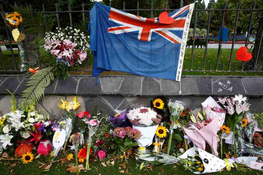 Flowers and a New Zealand national flag are seen at a memorial as tributes to victims of the mosque attacks near Linwood mosque in Christchurch March 16, 2019. u00e2u20acu2022 Reuters pic