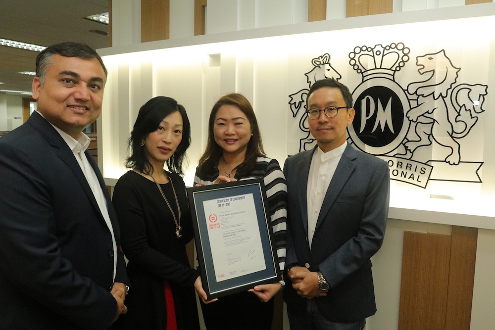 Chinmay Sharma (director people and culture), Amba Chan (director of finance), Veronica Choo (head of corporate communications) and Kang Tae Koo (managing director, Philip Morris Malaysia) pose with the EQUAL-SALARY certificate.