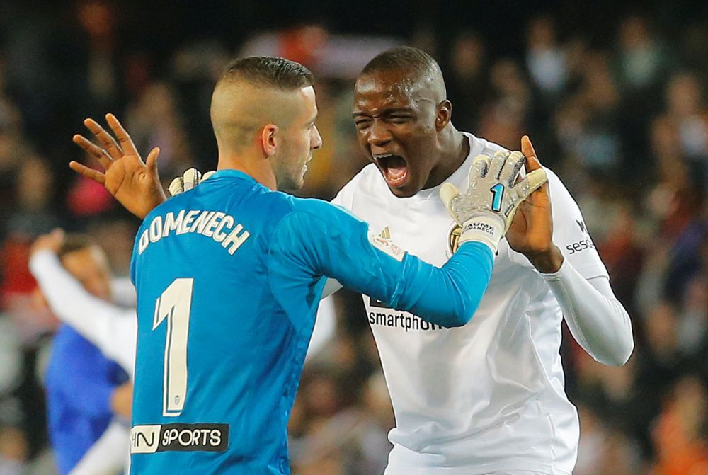 Valencia's Jaume Domenech celebrates with Mouctar Diakhaby after the match against Real Betis, February 28, 2019. u00e2u20acu2022 Reuters pic