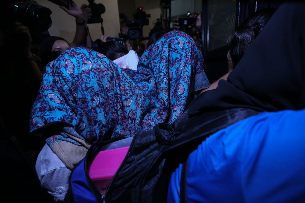 Samirah Muzaffar, the wife of Cradle Fund Sdn Bhd's late CEO Nazrin Hassan, is seen here being escorted by the police from the Petaling Jaya Magistrate's Court lock up March 4, 2019. u00e2u20acu201d Picture by Ahmad Zamzahuri