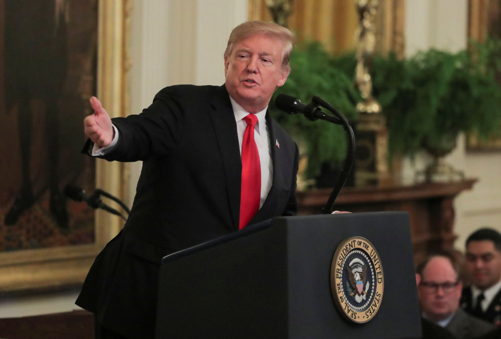 US President Donald Trump gestures towards the family of late US Army Staff Sgt Travis Atkins, during a ceremony in the White House in Washington, US, March 27, 2019. u00e2u20acu201d Reuters pic 