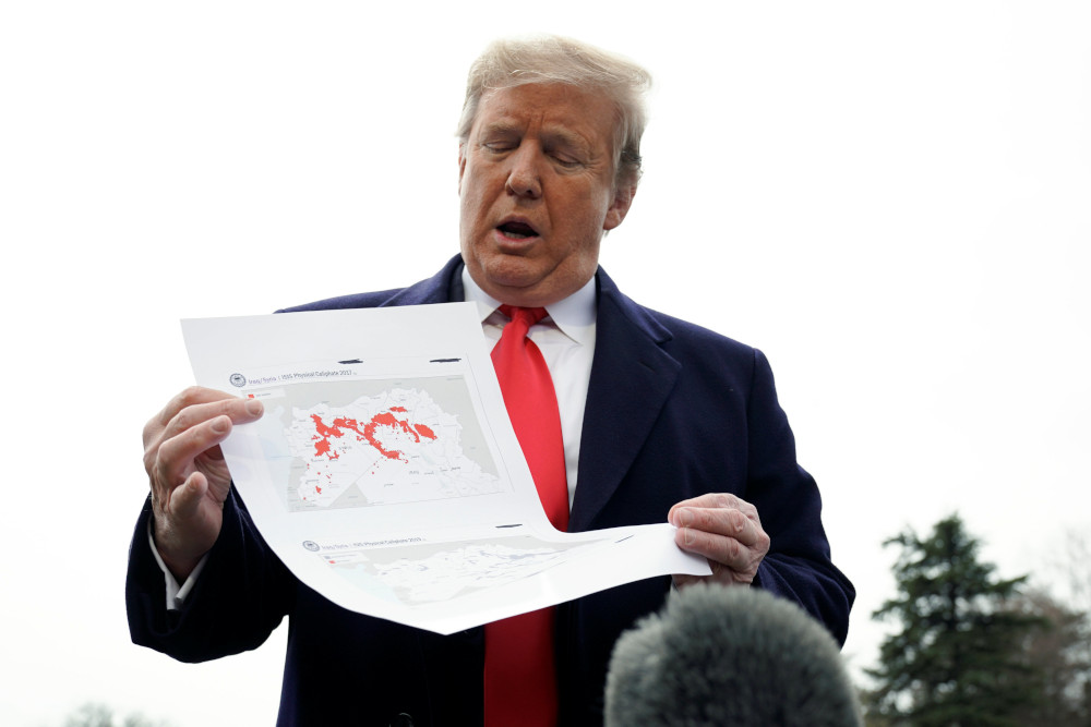 US President Donald Trump shows maps of Syria and Iraq depicting the size of the u00e2u20acu02dcISIS physical caliphateu00e2u20acu2122 as he talks to reporters upon departing on travel to Ohio from the White House in Washington, US, March 20, 2019. u00e2u20acu201d Reuters pic