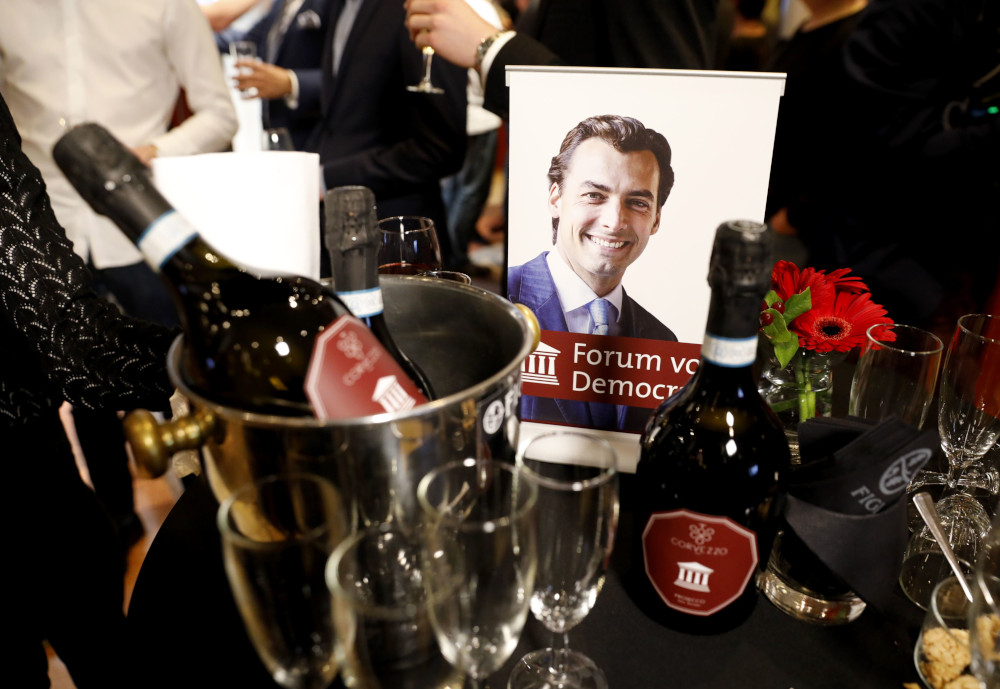 A campaign portrait of Dutch far-right Forum for Democracy (FvD) party Thierry Baudet is pictured next to alcohol bottles during a provincial elections party electoral gathering in Zeist March 20, 2019. u00e2u20acu201d AFP pic 