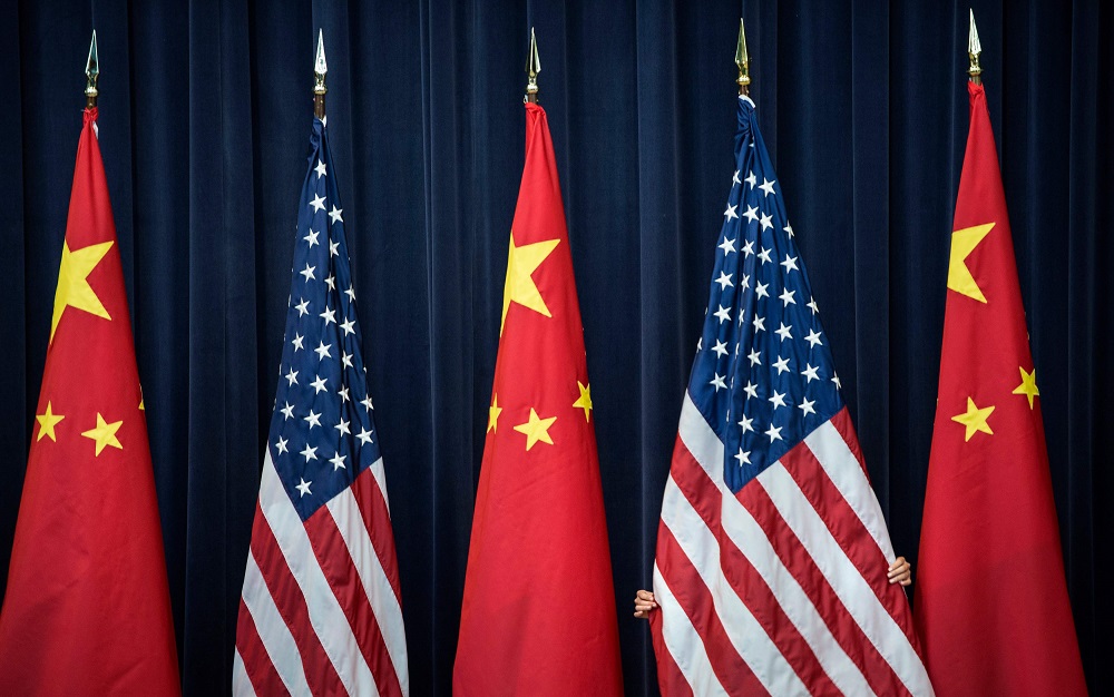 In this file photo taken on July 10, 2013, a staff member adjusts a US flag before the opening session of the US and China Strategic and Economic Dialogue at the US Department of State in Washington. u00e2u20acu2022 AFP pic