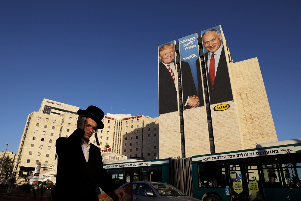 A man walks past a Likud election campaign billboard, depicting US President Donald Trump shaking hands with Israeli Prime Minister Benjamin Netanyahu, in Jerusalem February 4, 2019. u00e2u20acu201d Reuters pic       