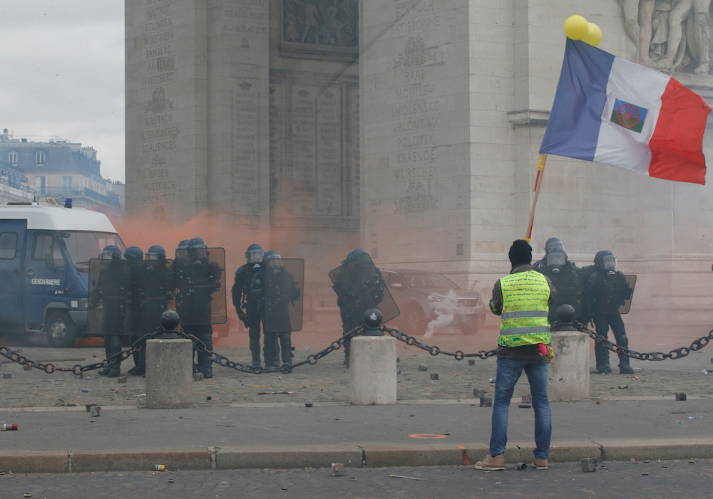 A protester wearing a yellow vest holds a flag during a demonstration by the u00e2u20acu02dcyellow vestsu00e2u20acu2122 movement in Paris, France, March 16, 2019. u00e2u20acu2022 Reuters pic