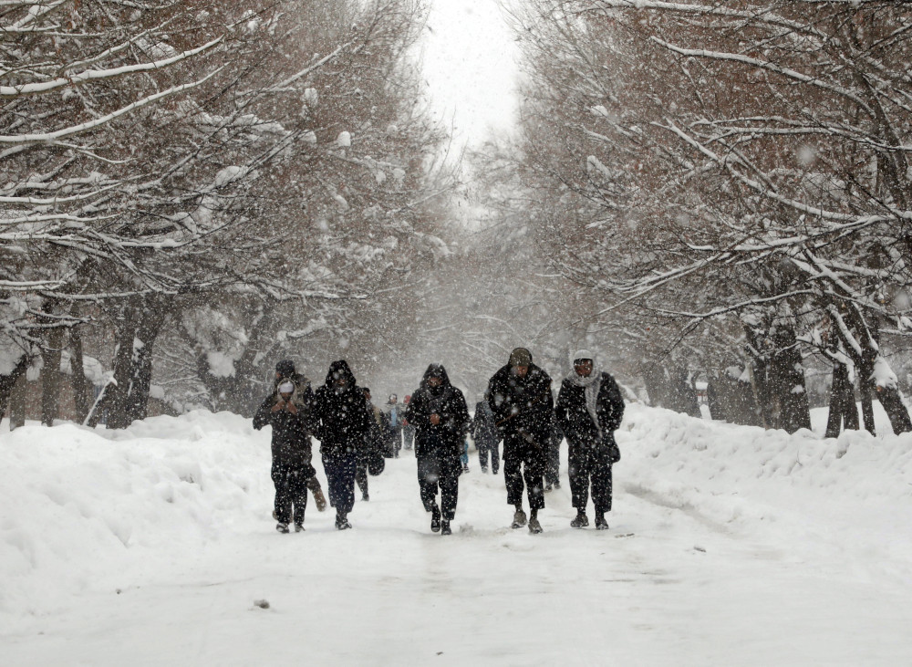Afghan men walk on the snow-covered ground on the outskirts of Kabul, Afghanistan, February 17, 2019. u00e2u20acu201d Reuters pic 