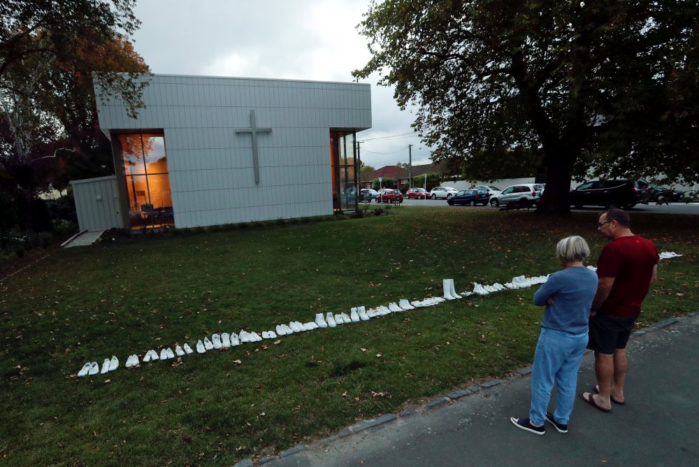 People look at fifty pairs of painted white shoes, laid out at All Souls Church, in memory of the victims of Friday's shooting, in Christchurch March 19, 2019. u00e2u20acu201d Reuters pic