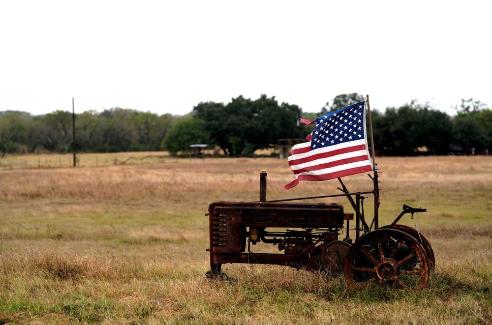 A tattered US flag flies on an old tractor in a farm field outside Sutherland Springs, Texas November 8, 2017. u00e2u20acu201d Reuters pic