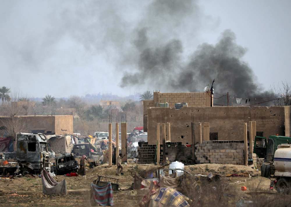 Islamic State members walk in the last besieged neighbourhood in the village of Baghouz, Deir Al Zor province, Syria March 10, 2019. u00e2u20acu201d Reuters pic