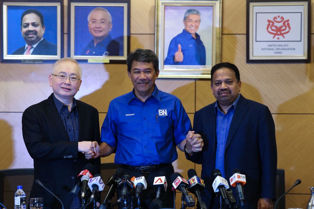 Umnou00e2u20acu2122s Datuk Seri Mohamad Hasan shakes hands with MCA President Datuk Seri Wee Ka Siong and MIC President Tan Sri S Vigneswaran after the BN supreme council meeting, March 8,2019. u00e2u20acu2022 Picture by Ahmad Zamzahuri