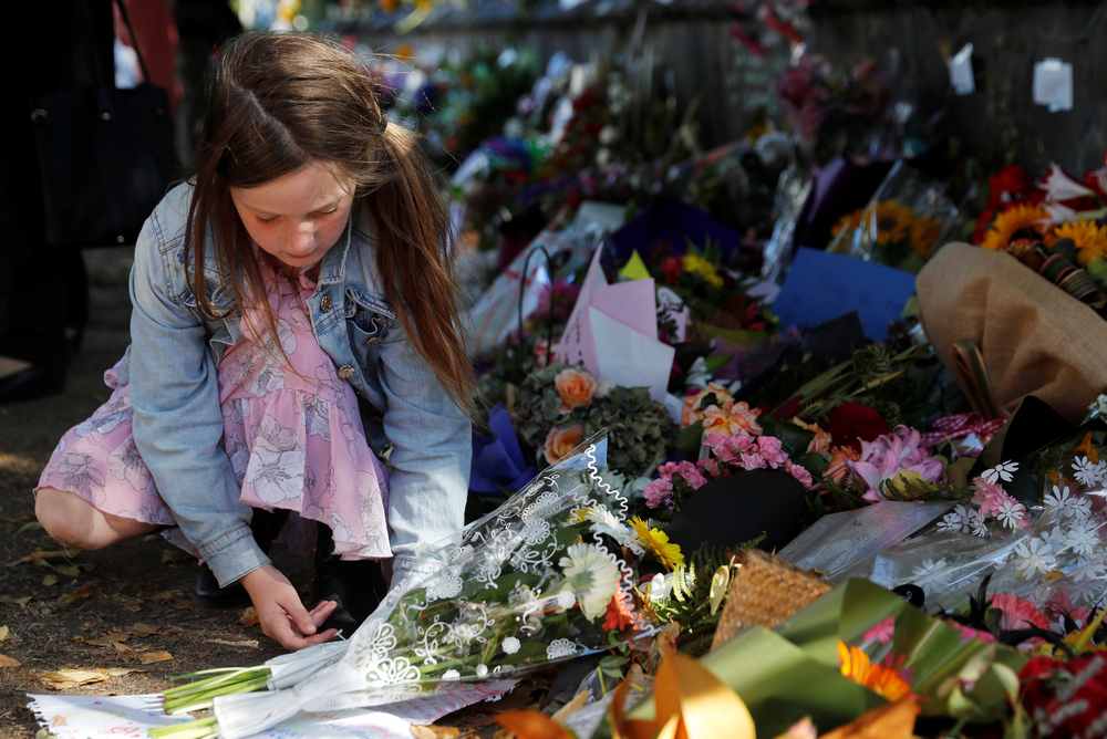 A girl places flowers at a memorial site for victims of Friday's shooting, in front of Christchurch Botanic Gardens in Christchurch, New Zealand March 19, 2019. u00e2u20acu201d Reuters pic