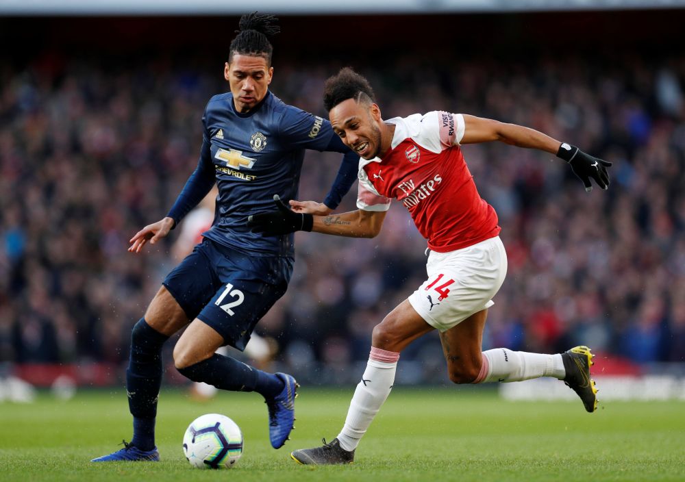 Arsenal's Pierre-Emerick Aubameyang in action with Manchester United's Chris Smalling. u00e2u20acu201d Reuters pic