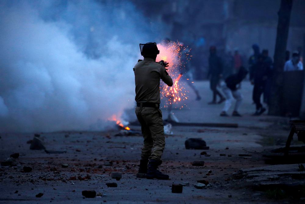 An Indian police officer fires a tear gas shell towards demonstrators, during a protest against the recent killings in Kashmir, in Srinagar May 8, 2018. u00e2u20acu201d Reuters pic