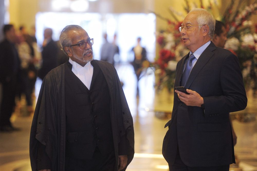 Datuk Seri Najib Razak (right) speaks to lawyer Tan Sri Muhammad Shafee Abdullah at the court of appeal in Putrajaya March 15, 2019. u00e2u20acu201d Picture by Shafwan Zaidon