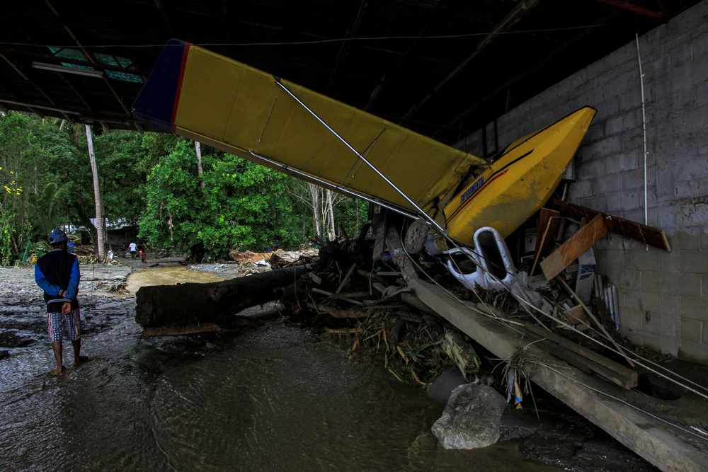 Man walks near a damaged aircraft following flash floods in Sentani, Papua, Indonesia March 17, 2019. u00e2u20acu201d Antara Foto/Gusti Tanati via Reuters