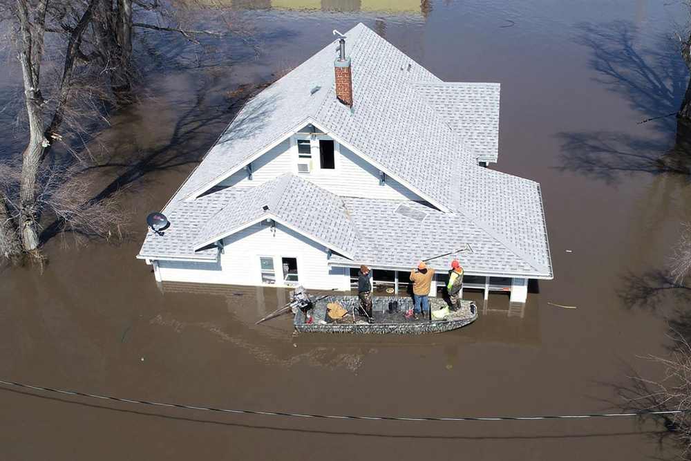 Lanni Bailey and a team from Muddy Paws Second Chance Rescue enter a flooded house to pull out several cats during the Missouri River floods near Glenwood, Iowa March 18, 2019. u00e2u20acu201d Passport Aerial Photography handout via Reuters