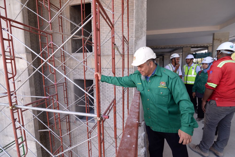 DOSH Penang director Jaafar Leman checks on a scaffolding during his visit to a construction site in George Town March 6, 2019. u00e2u20acu2022 Picture by Steven Ooi KE