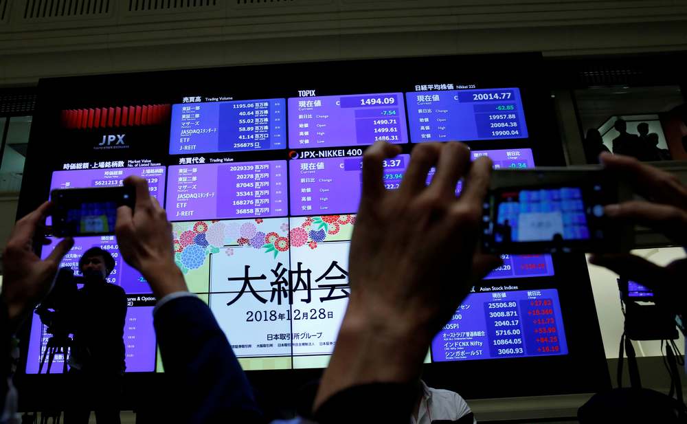 Onlookers snap pictures of a stock quotation board at the end of trading in 2018 at the Tokyo Stock Exchange  December 28, 2018. u00e2u20acu201d Reuters pic