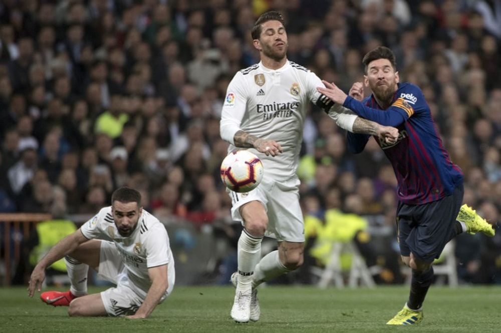 Barcelonau00e2u20acu2122s Argentinian forward Lionel Messi (right) vies with Real Madridu00e2u20acu2122s Spanish defender Sergio Ramos during their Spanish league match at the Santiago Bernabeu stadium in Madrid on March 2, 2019. u00e2u20acu201d AFP pic