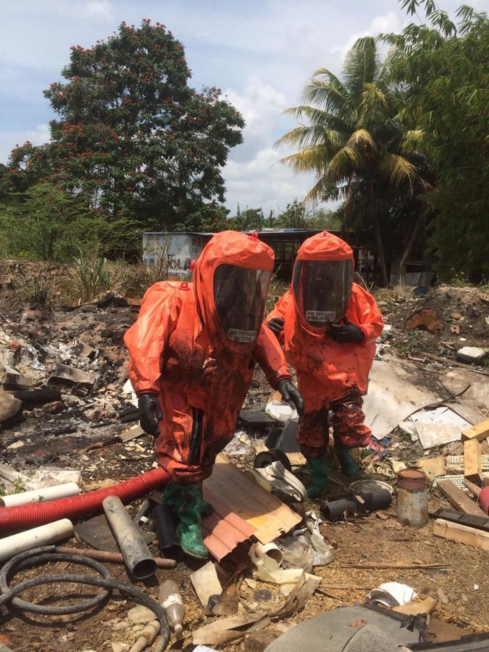 Johor Fire and Rescue Department’s Hazmat unit personnel take water samples along Sungai Kim Kim following 31 victims who were affected by chemical fumes. — Picture courtesy of the Johor Fire and Rescue Department.