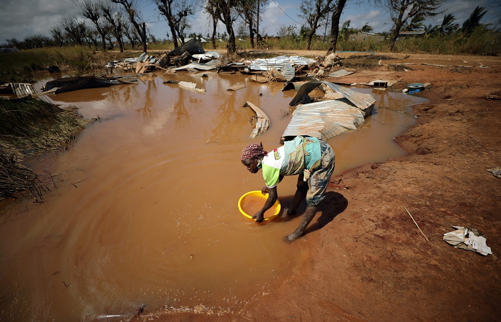 A woman collects water for washing as flood waters begin to recede in the aftermath of Cyclone Idai, in Buzi near Beira, Mozambique March 24, 2019. u00e2u20acu201d Reuters pic       