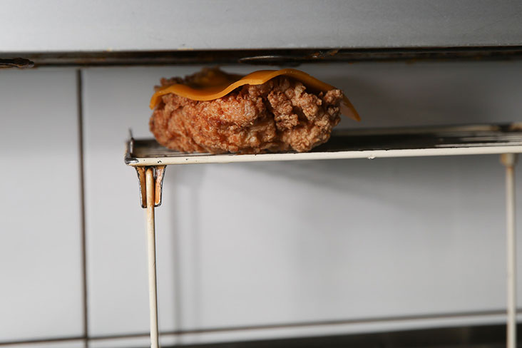 For the Hook, Line & Stinker, fried chicken thigh has a piece of cheese melted over it.