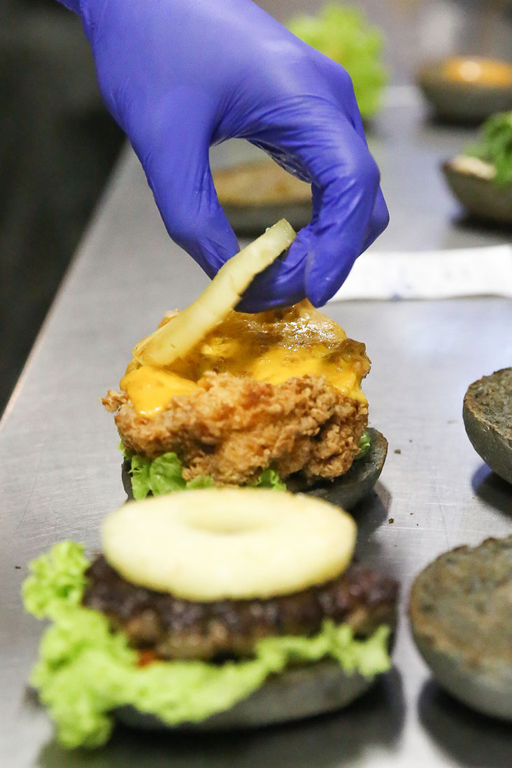 A grilled pineapple ring adds a touch of juiciness and sweetness to the whole burger.