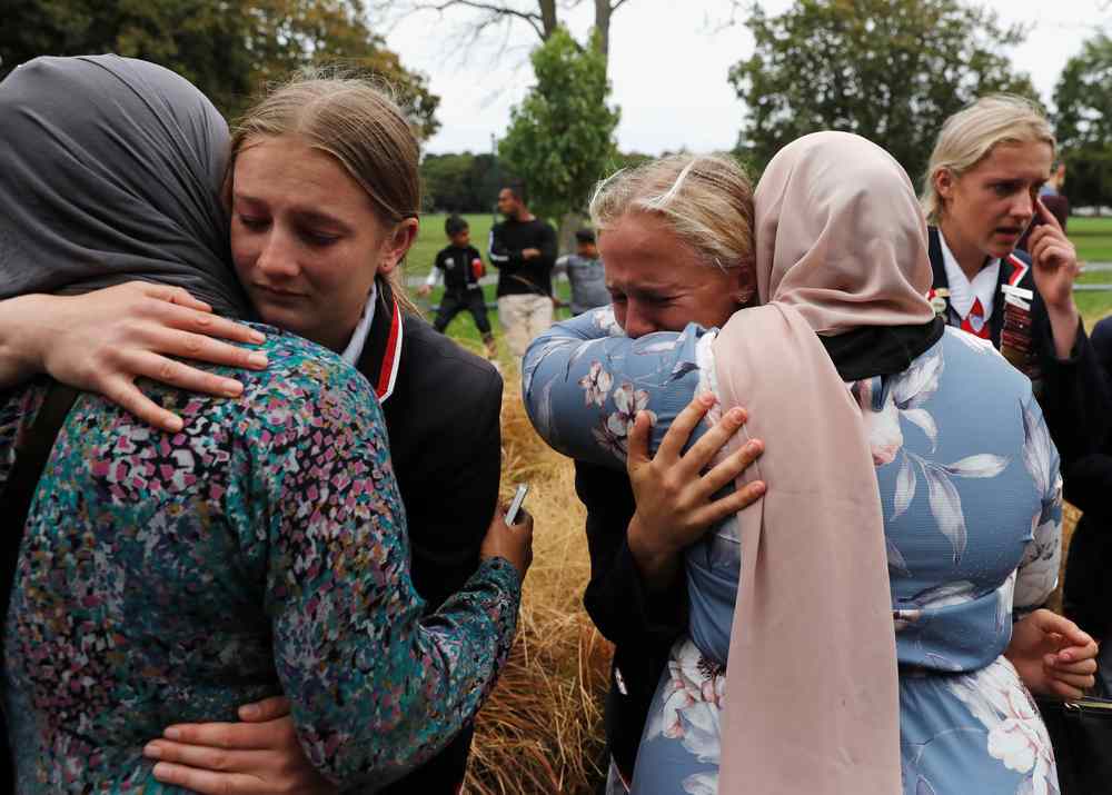 Students from a Christian high school embrace as they give hugs to Muslims waiting for news of their relatives at a community centre, following Friday's shooting in Christchurch, New Zealand March 18, 2019. u00e2u20acu201d Reuters pic