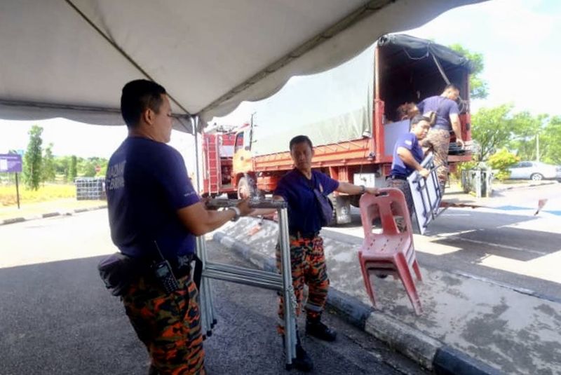 Personnel from Johor Fire and Rescue Departmentu00e2u20acu2122s hazardous material unit pack up their gear at the Pasir Gudang Municipal Council Indoor Stadium following improved conditions today. u00e2u20acu201d Picture by Ben Tan