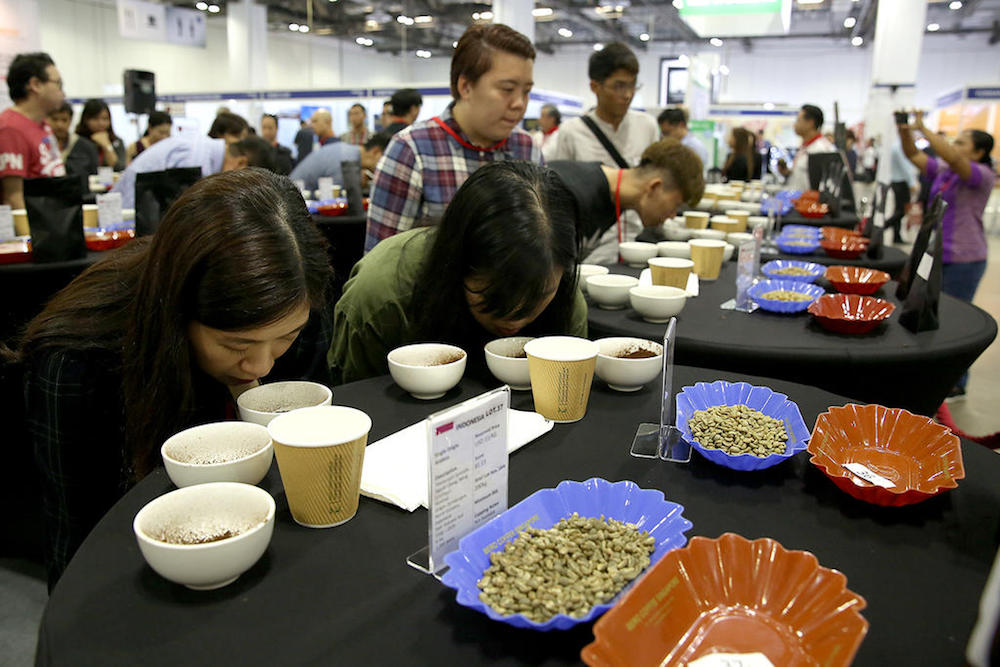 Coffee buyers smell the dry aroma of coffees during the cupping session of the first Asean Coffee Federation Specialty Coffee Auction. u00e2u20acu201d TODAY pic