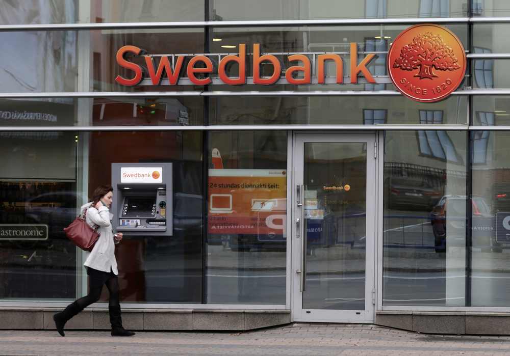 A woman walks past a Swedbank branch in Riga October 21, 2014. u00e2u20acu201d Reuters pic