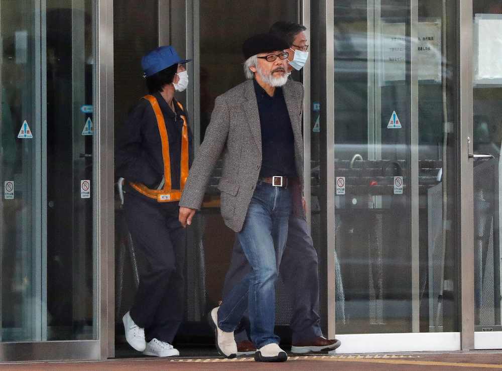 Takashi Takano, a lawyer for Carlos Ghosn, walks out the main building as he leads a group of security guards surrounding Carlos Ghosn (not in picture) at the Tokyo Detention House March 6, 2019. u00e2u20acu201d Reuters pic