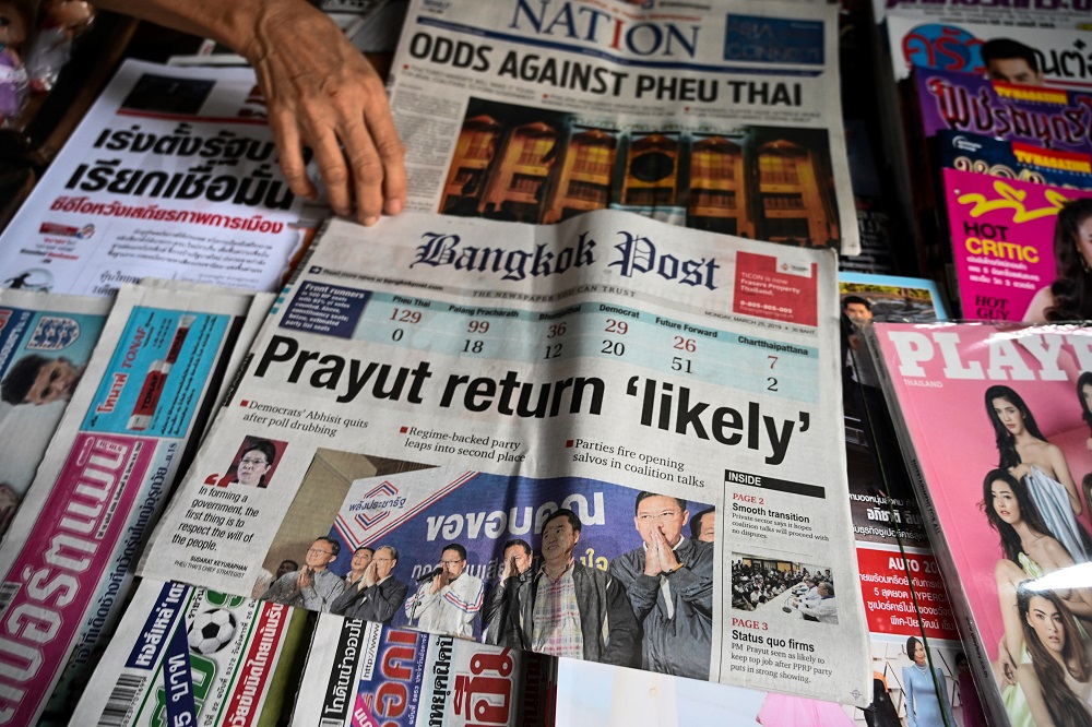 A vendor arranges newspapers at her newsstand in Bangkok on March 25, 2019, a day after Thailandu00e2u20acu2122s general election. u00e2u20acu201d AFP pic    