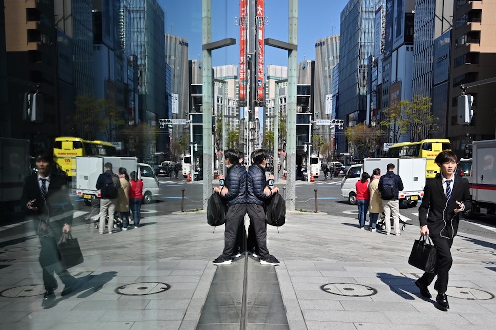 A businessman runs down the pavement in Tokyou00e2u20acu2122s Ginza district April 3, 2019. u00e2u20acu201d AFP pic