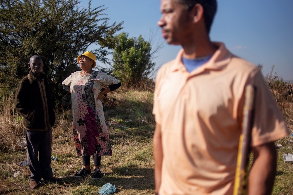Members of the coloured community of Eldorado Park look on during a land grabbing action on the outskirts of Johannesburg April 18, 2019. — AFP pic