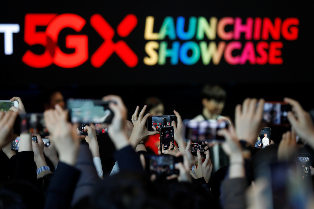 People take photographs during a launching ceremony for SK Telecom's 5G service, in Seoul April 3, 2019. u00e2u20acu201d Reuters pic