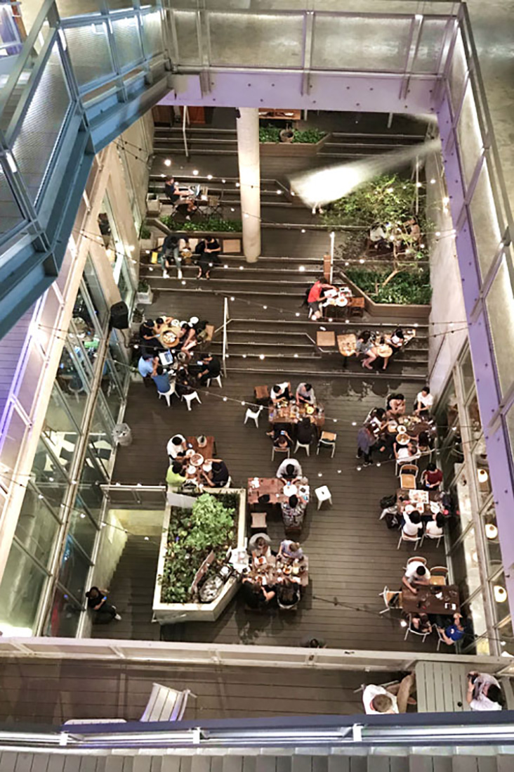 Dine 'al fresco' in an open mezzanine area lined with greenery at The Commons.