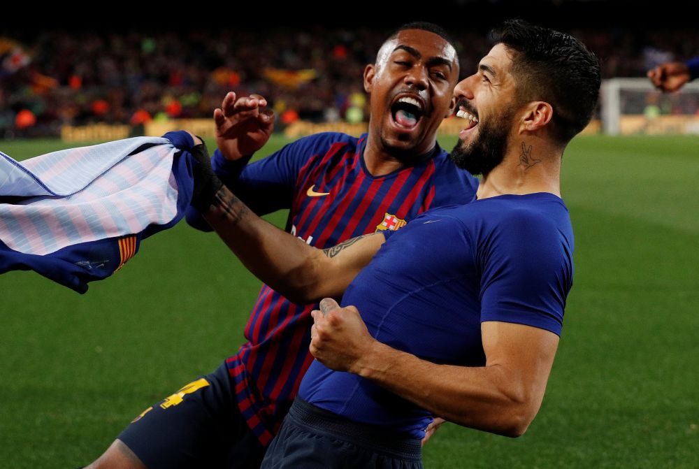 Barcelonau00e2u20acu2122s Luis Suarez celebrates scoring their first goal with Malcom in the FC Barcelona v Atletico Madrid match in Barcelona April 6, 2019. u00e2u20acu201d Reuters pic