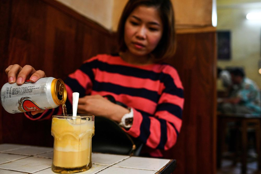 Malaysian tourist ST Lim drinking egg beer at the Giang Cafe in Hanoi, April 4, 2019. u00e2u20acu201d AFP pic