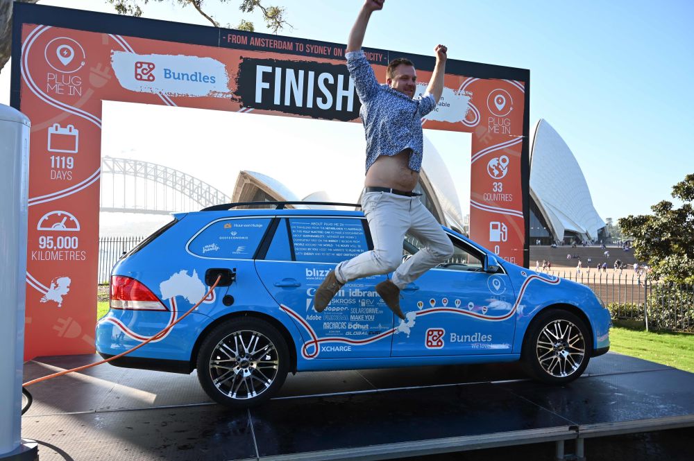 Dutch driver Wiebe Wakker celebrates after driving his retrofitted station wagon nicknamed u00e2u20acu02dcThe Blue Banditu00e2u20acu2122 onto a platform to complete a round-an-world trip in an electric car in Sydney April 7, 2019. u00e2u20acu201d AFP pic