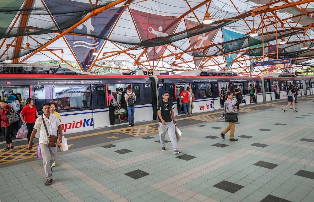 Passengers exiting a train carriage at the Bukit Jalil LRT station. — Picture by Firdaus Latif.