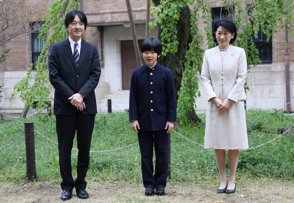 Prince Hisahito, accompanied by his parents Prince Akishino and Princess Kiko, poses for photos at Ochanomizu University junior high school before attending the entrance ceremony in Tokyo April 8, 2019. u00e2u20acu201d Koji Sasahara/Pool handout via Reuters