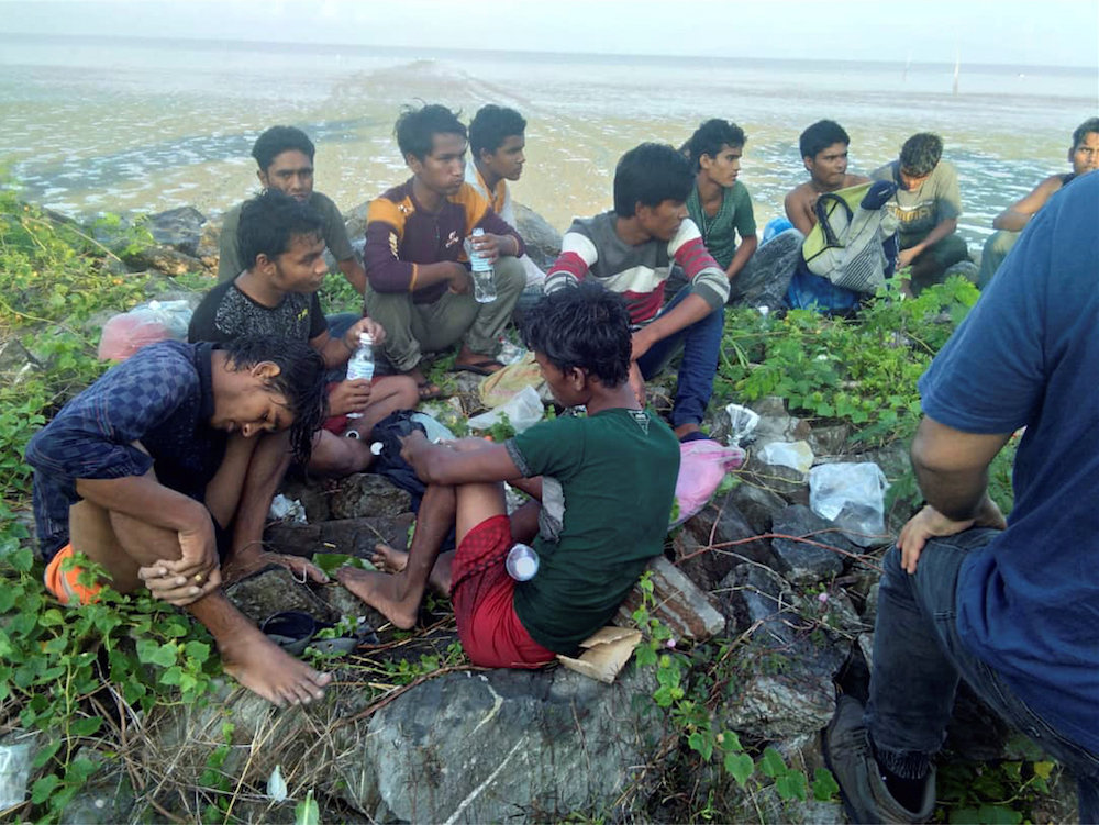Dozens of Rohingya who were dropped off from a boat are pictured on a beach near Sungai Belati, Perlis in this undated handout photo released April 8, 2019. u00e2u20acu201d Royal Malaysian Police handout via Reuters