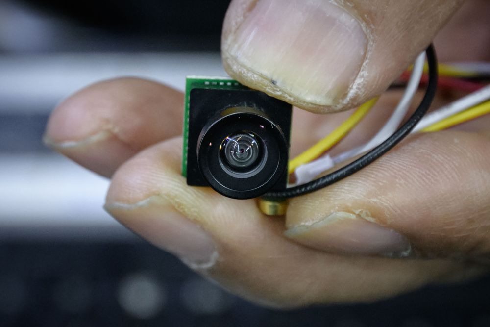 An electrical component vendor and technician holds a mini camera unit capable of being built into custom-made devices, at his store in a market in Seoul, March 26, 2019 u00e2u20acu201d AFP pic